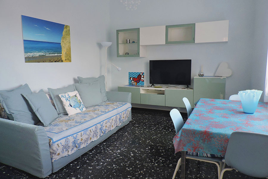 Soggiorno con divano, tavolo da pranzo e Smart TV